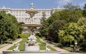 Ein Springbrunnen und der Königspalast im Hintergrund.